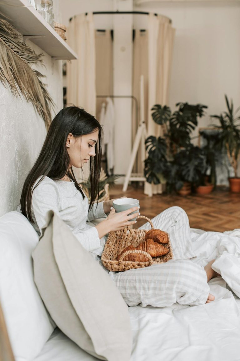 woman eating comfort food in bed. ADHD linked to porn use in women